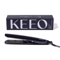 Black hair straightener with 'KEEO' branding next to its packaging on a white background