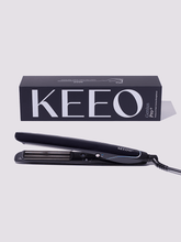 Black hair straightener with Keeo branding on a light gray background